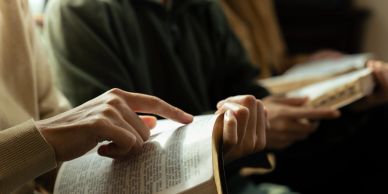 People reading and pointing at books together.