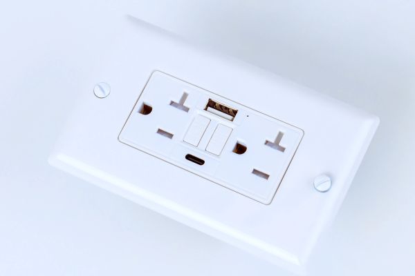 White electrical switch panel with sockets and USB ports.