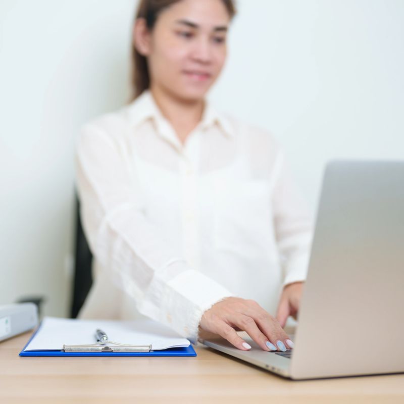 Asian woman working with computer laptop, female businesswoman reading and writing report or sign contract with documents folder stack at home or office. business financial concept