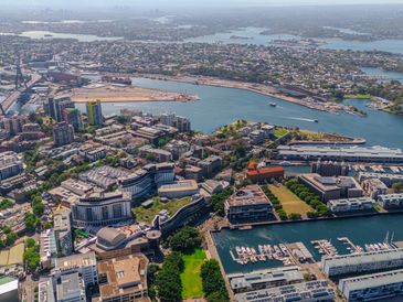 Aerial view of a coastal city with buildings and water bodies.