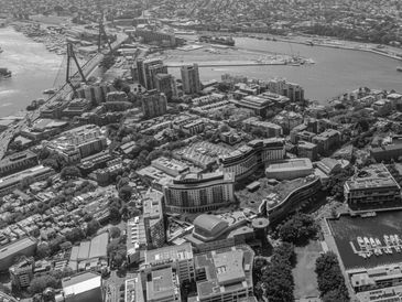Aerial view of a coastal city with buildings and water bodies.