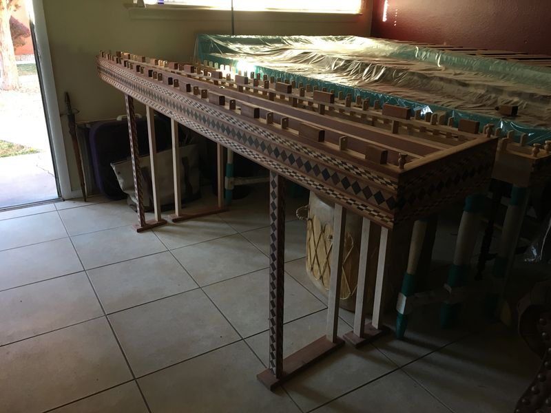 A handcrafted wooden table with intricate patterns set indoors highlighting its beauty and design.