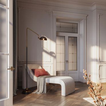 Elegant lounge chair with floor lamp in a sunlit room.