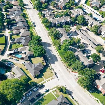 Aerial view of a suburban neighborhood with houses and trees.