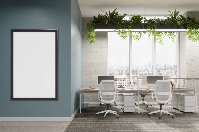 Modern Open Plan Empty Office With Creeper Plants And Close-up View Of Empty Poster On The Wall