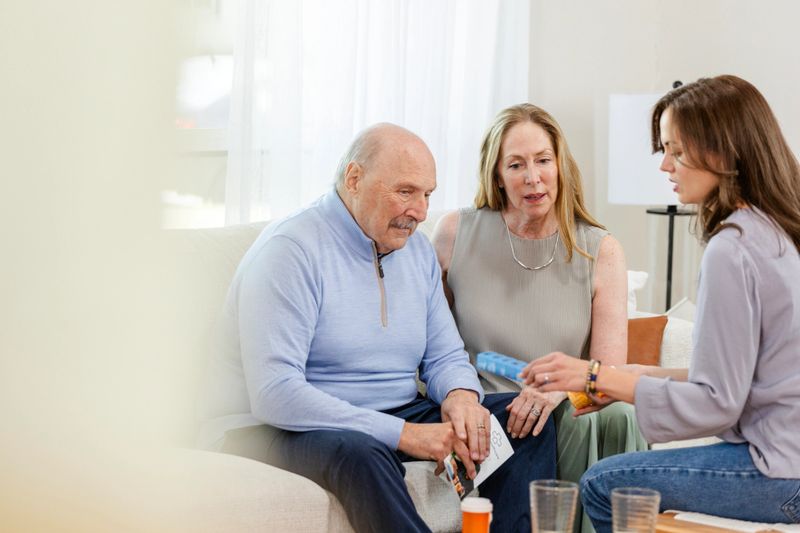 For easier use, the adult daughter organized her father's medications for him and proudly shows him the pill case.