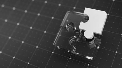 A white puzzle piece on a transparent puzzle piece on a dark grid surface.