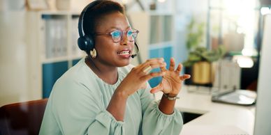 Professional adviser using a headset to provide attentive support from a bright office