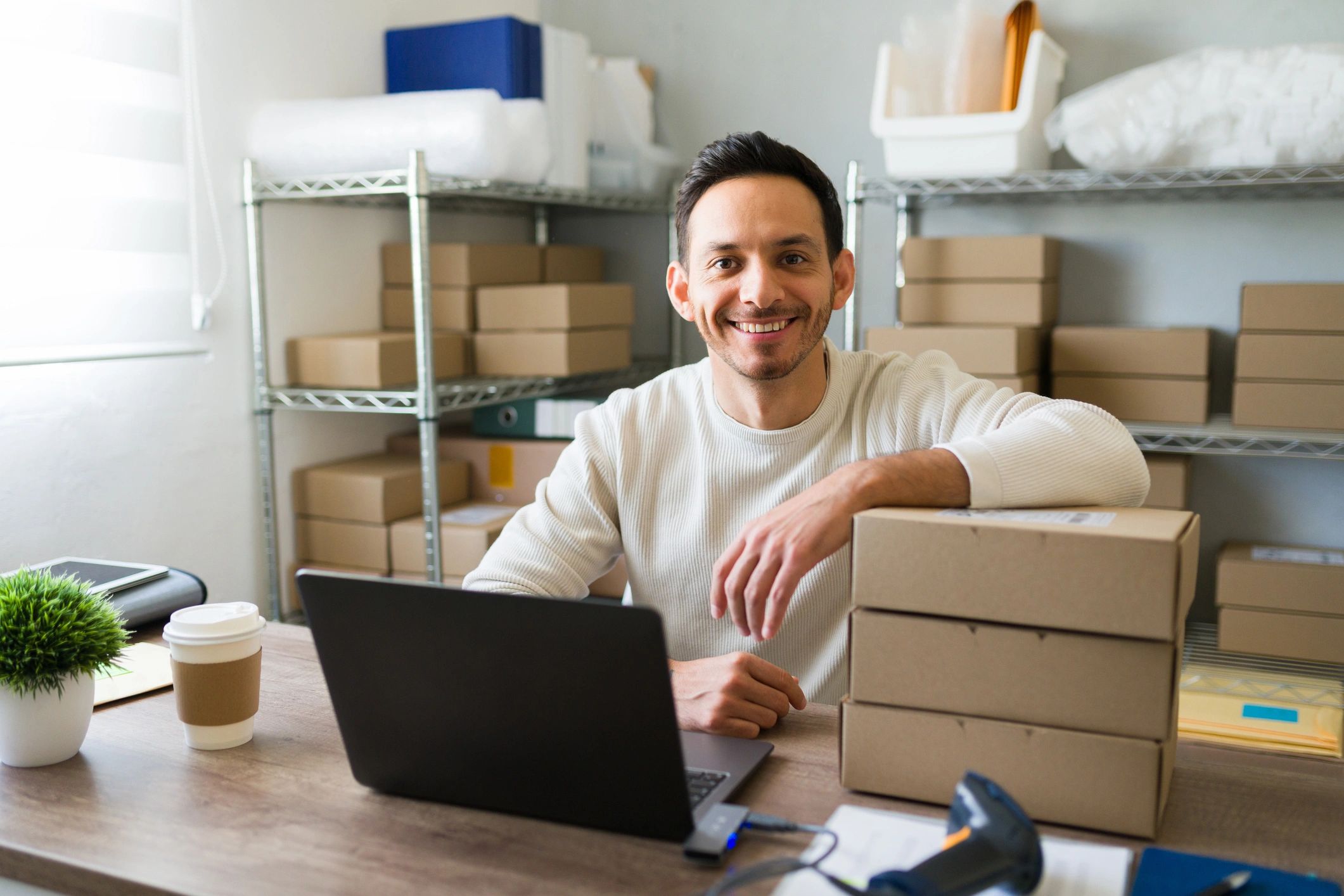 Man starting a dropshipping business with a laptop from home.