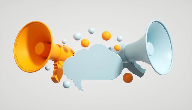 A 3D composition illustrating digital marketing and social media concepts. Two megaphones face opposite directions, symbolizing diverse perspectives and communication channels. A cloud-shaped speech bubble between them represents stored thoughts, online blogs, and shared ideas from cloud-based platforms. This design highlights the power of social media in amplifying various viewpoints and sharing stored content.