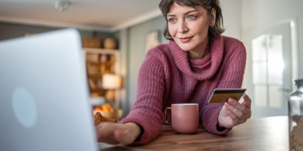 Woman shopping online with a credit card.
