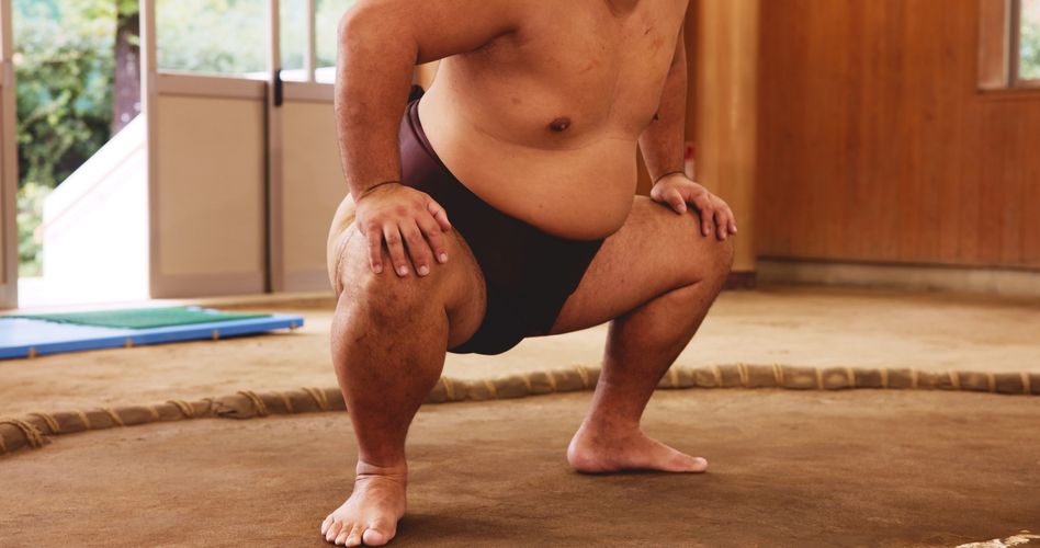 Stack of books next to pencils in a holder and a camera.