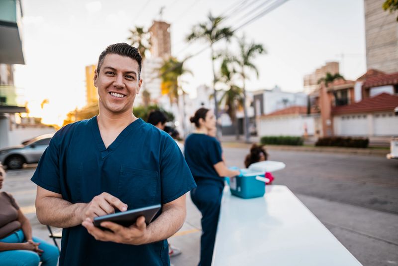 Portrait of mid adult nurse man outdoors