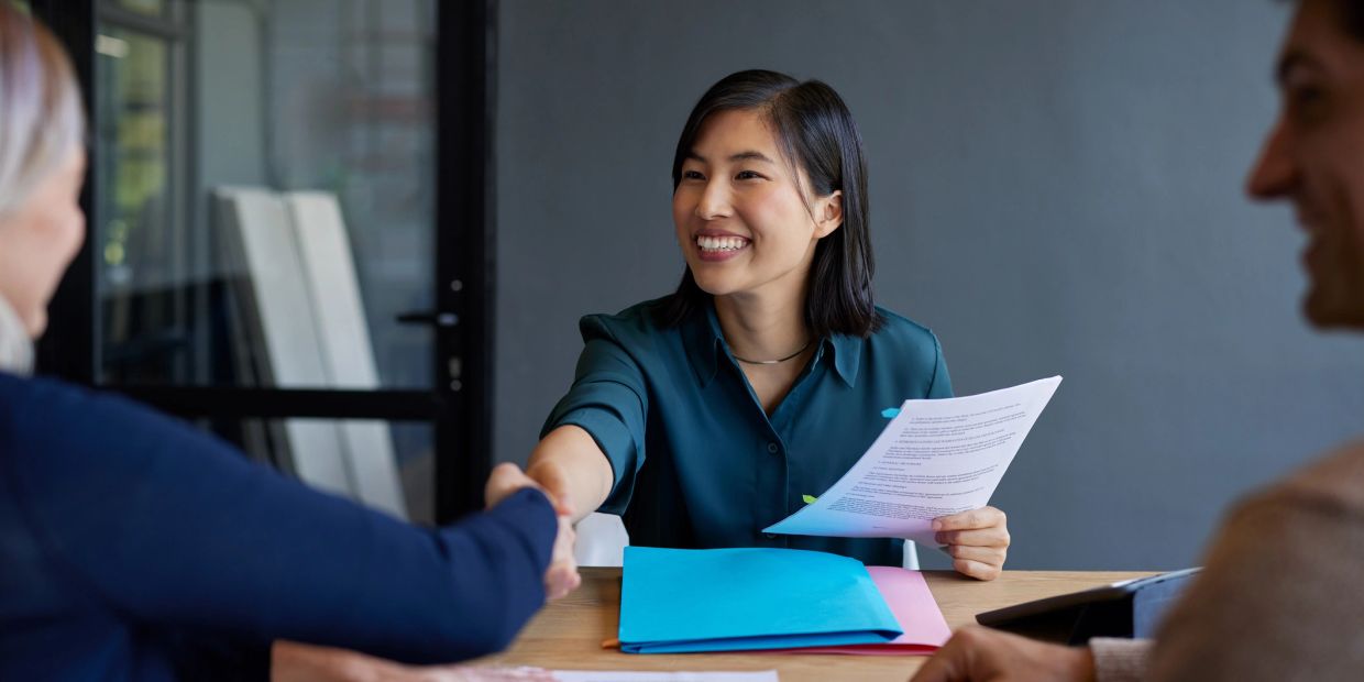 Woman shaking hands during a meeting.