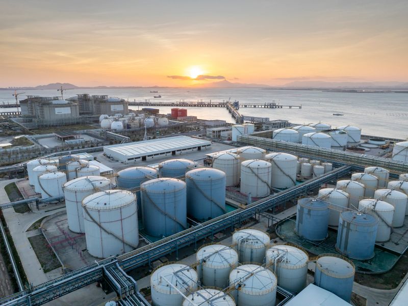 Rows of oil storage tanks at a seaside chemical plant