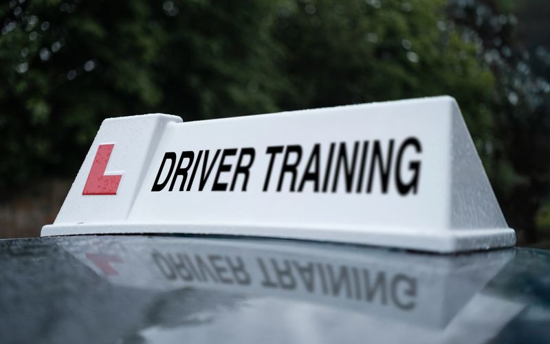A Driver Training Sign On The Top Of A Car In The UK