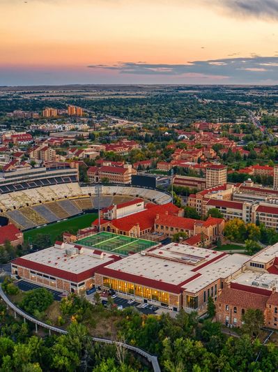 Aerial view of a university campus with a stadium at sunset.