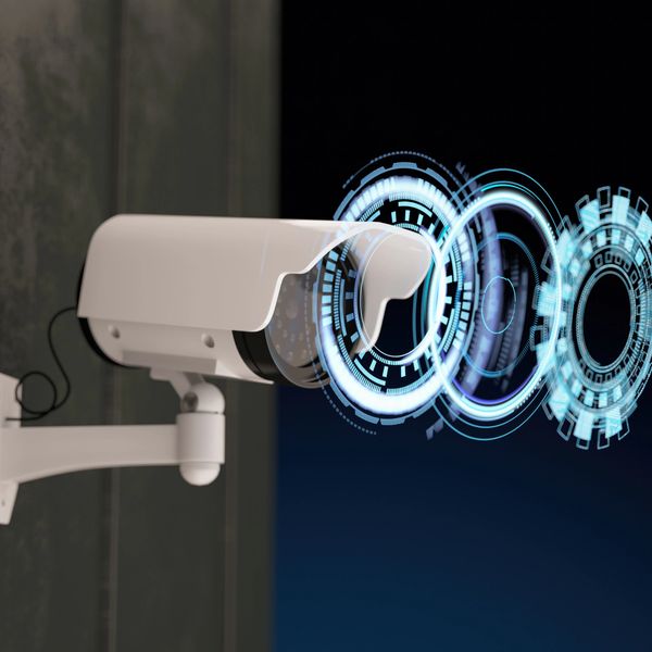 Security camera with digital futuristic interface overlay.