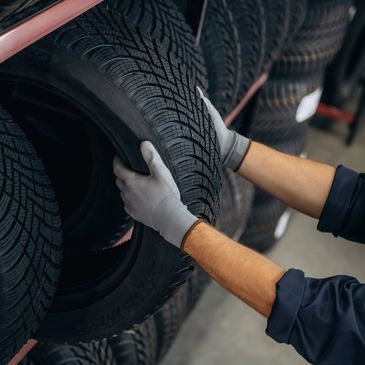 Technician performing tire service at Troy's Corner Auto Care