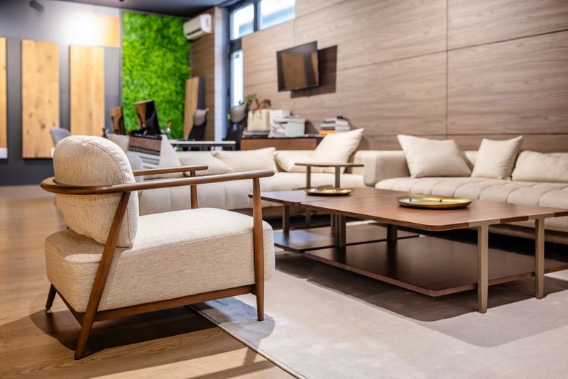 An elegant lounge area featuring beige sofas and a wooden coffee table, styled with neutral decor elements, creating a pleasantly chic and tranquil atmosphere.