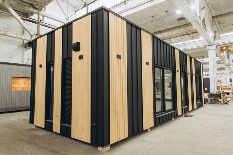 Modular tiny house being built inside a large industrial building, showing the efficiency and speed of prefabricated construction