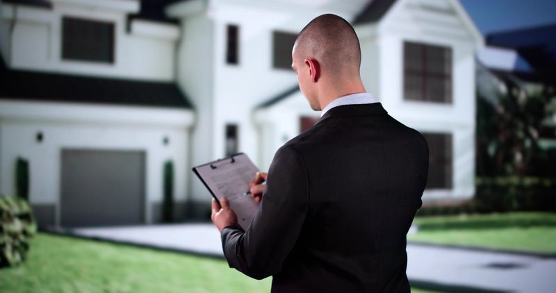 Real Estate Property Appraisal. Man Inspecting House