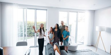 Real estate agent showing family a house.