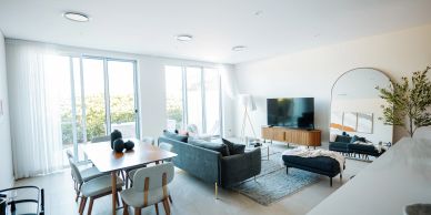 Bright modern living and dining area with large windows.