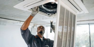 Technician repairing an air conditioning unit.