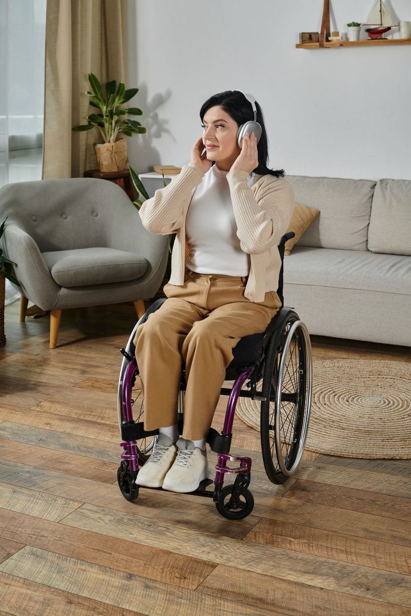 Beautiful woman in a wheelchair engages in remote work while listening to music comfortably.