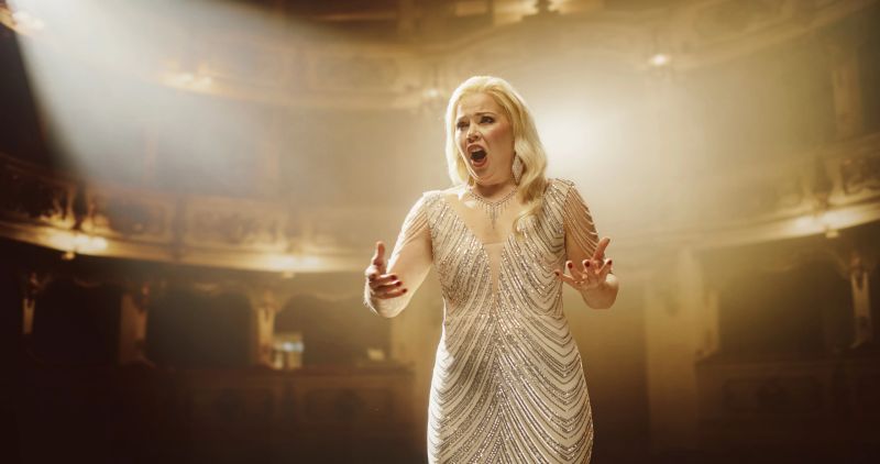 Beautiful Blonde Vocalist Radiating Confidence, Singing Opera for Audience on a Historic Theater Stage.