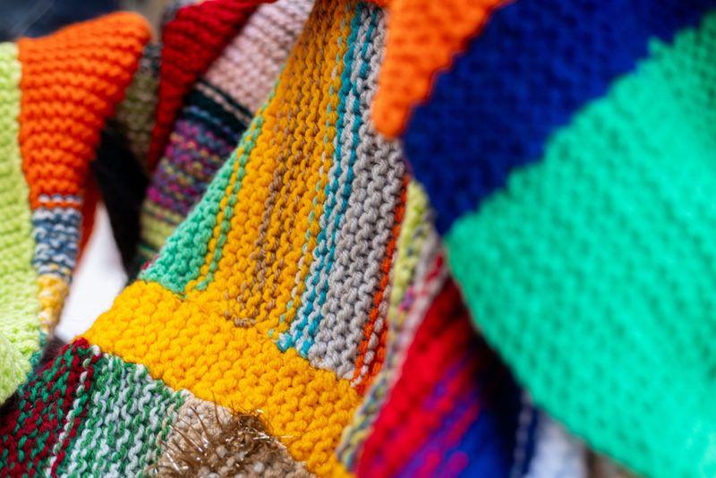 Close-up shot of a colourful knitted blanket. The blanket consists of various patterns and colours.

Videos are available similar to this scenario.