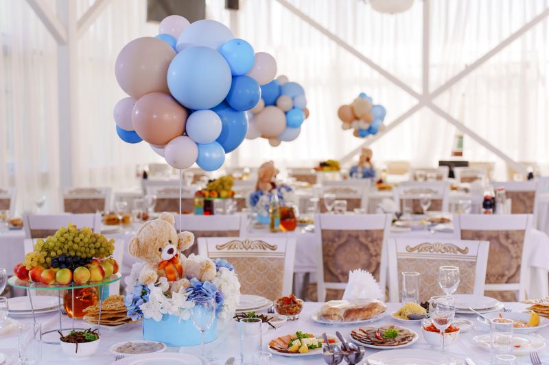 Setting and decorating tables for a children's party in the banquet hall. Balloons and teddy bears at a birthday party in a restaurant.
