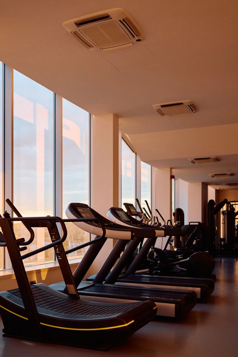 Gym with modern exercise equipment without people. Copy space.