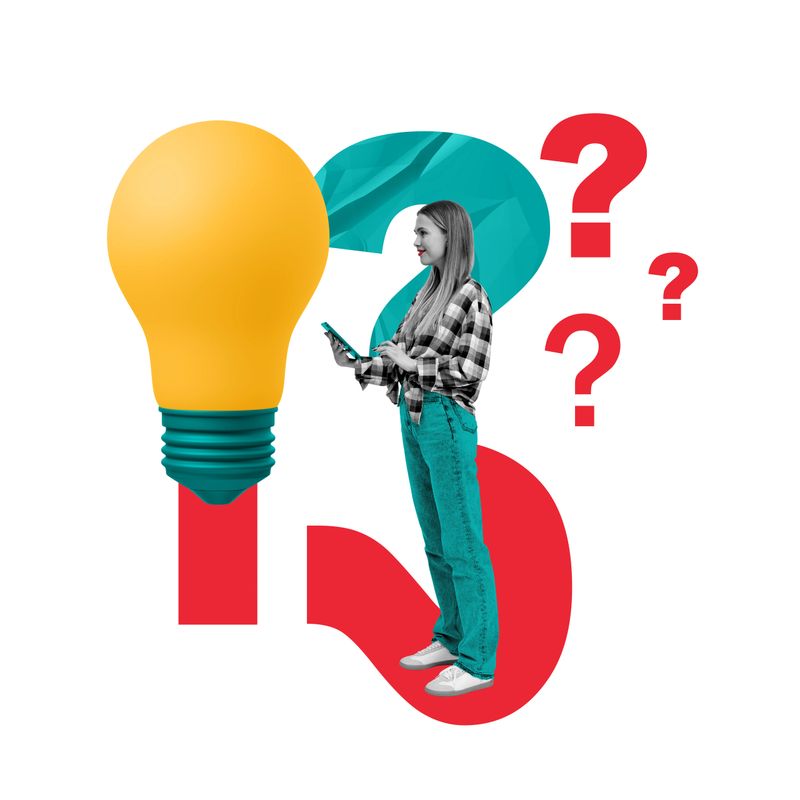 Smiling young woman working in tablet, standing near big yellow lightbulb, question marks on white background. Concept of startup, creativity, idea and inspiration