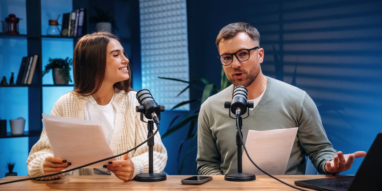 Two people recording a podcast in a studio.