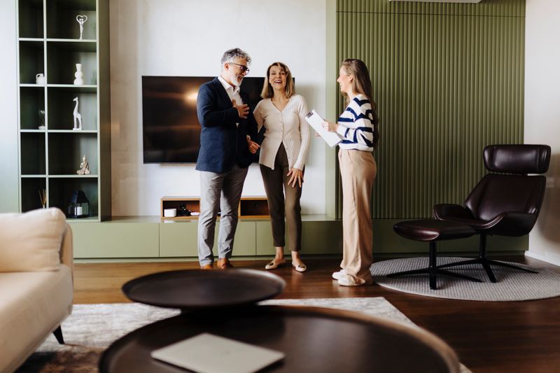 Senior couple talking with female financial or real estate advisor