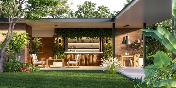 Modern outdoor patio with wooden furniture and lush greenery.