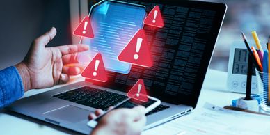 Person facing phone security warnings on a laptop screen.