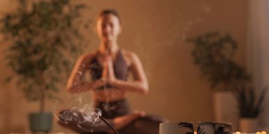 Meditation with incense and candles creating a calm atmosphere.