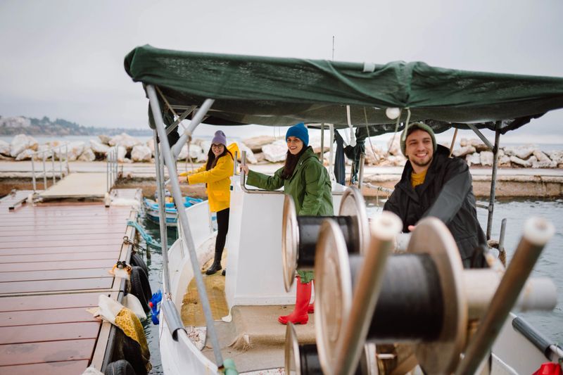 Young smiling sailors having a great day on the sea