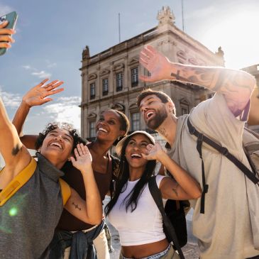 Group of friends taking a selfie outdoors during daytime.