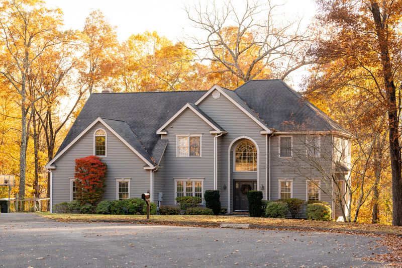 A front view of a beautiful American house and autumn leaves in the background