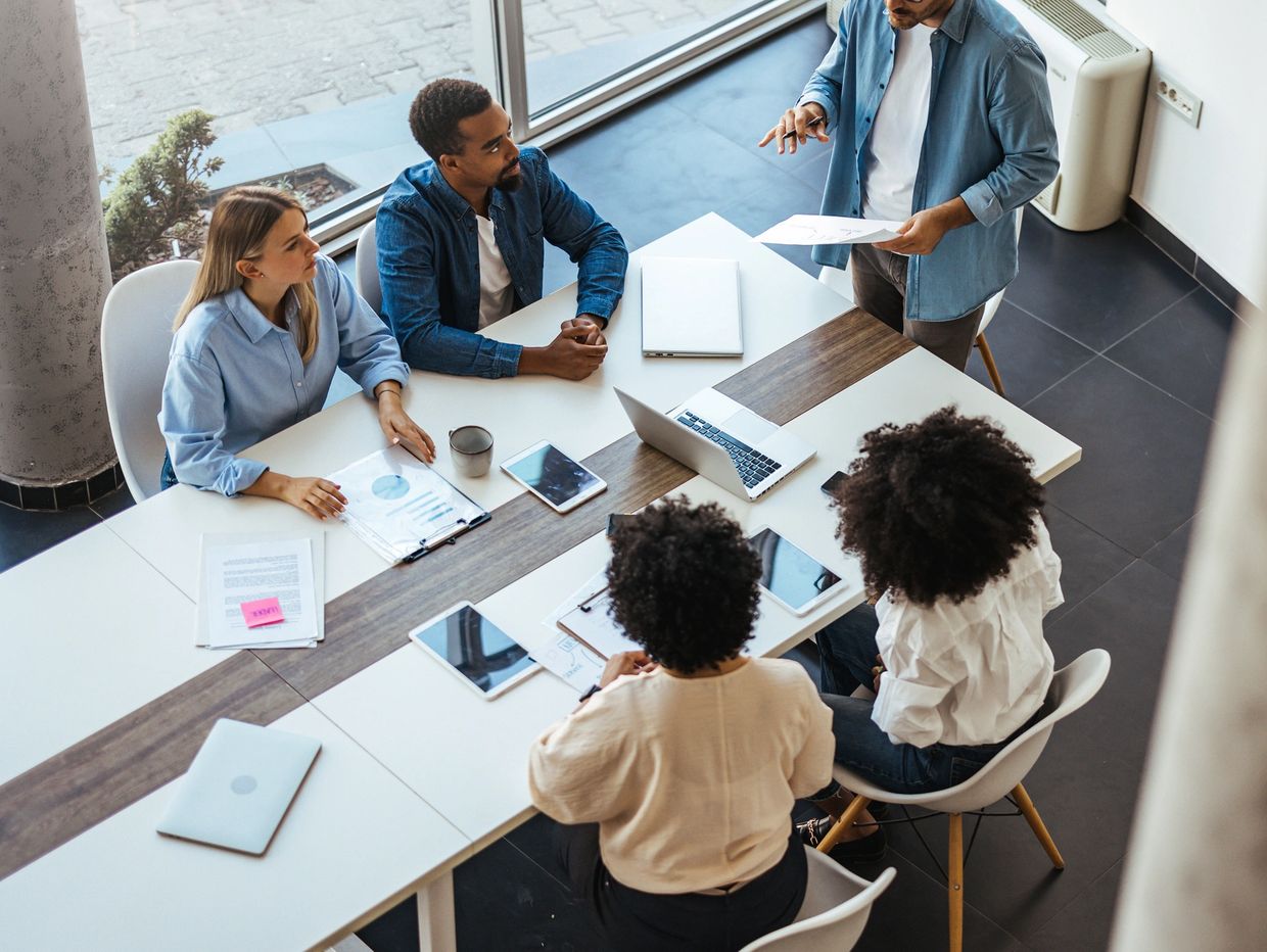 Team meeting reviewing client solar projects from MCS-certified installers.