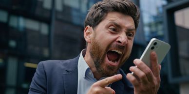 Angry man yelling at his phone.