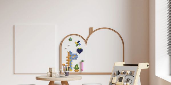 Modern children's playroom with wooden activity board and colorful wall art.