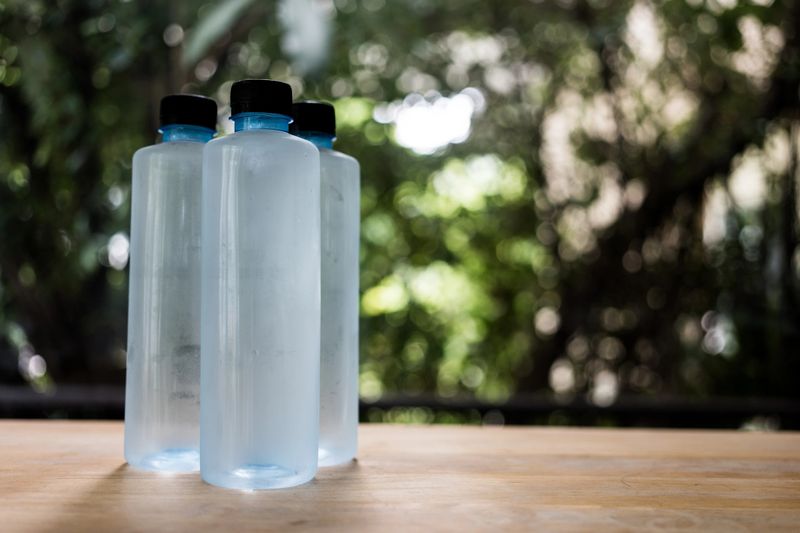 Cool plastic water bottle mockup on wood table