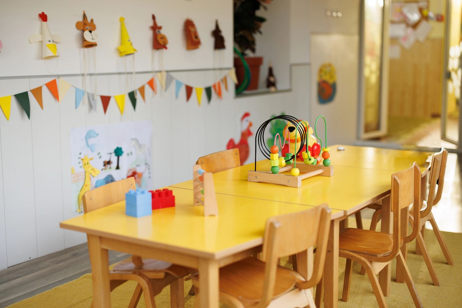 Colorful children's playroom with wooden furniture and educational toys.