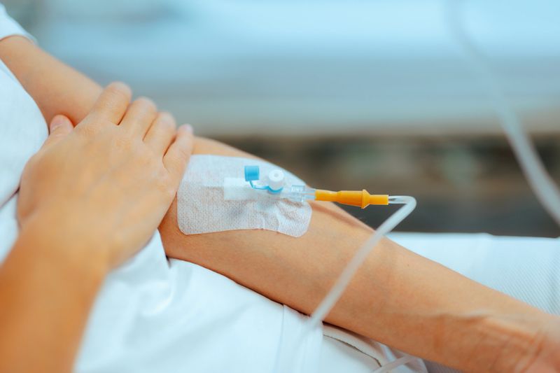 Person in need of emergency help receiving medication with medical procedure