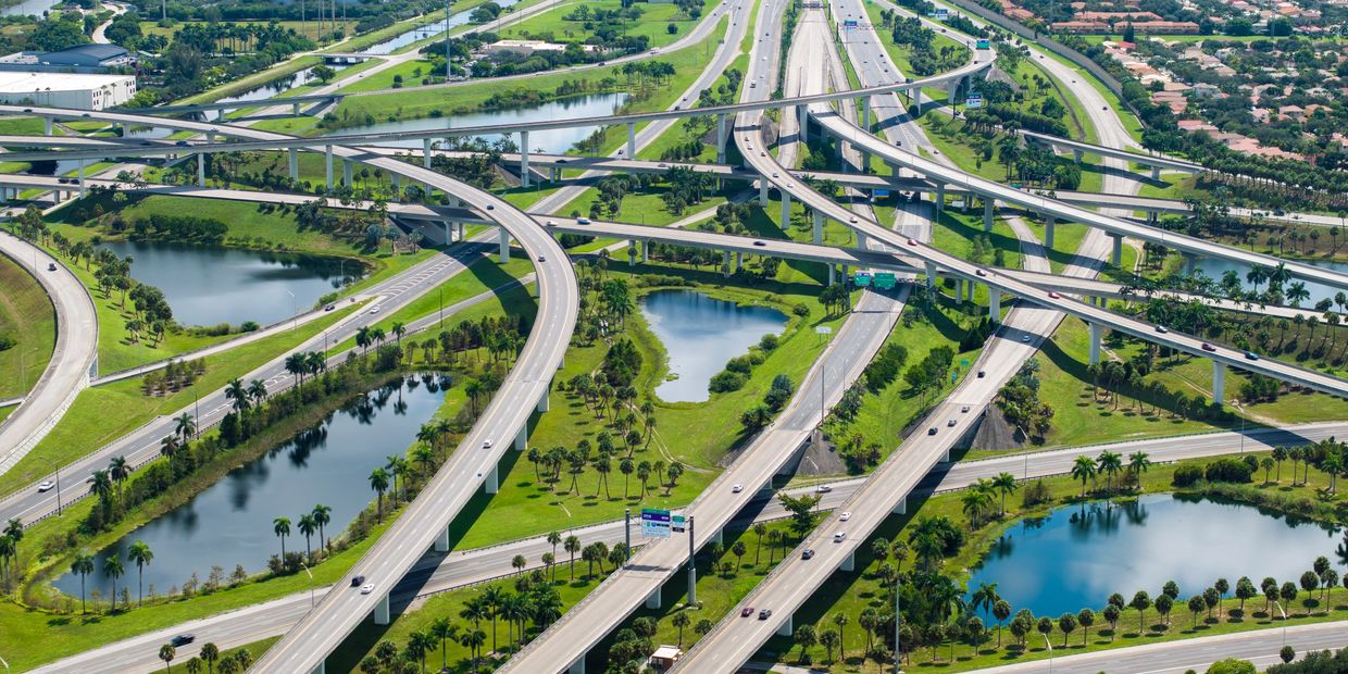 Miami infrastructure with highways, bridges, buildings, and construction projects.